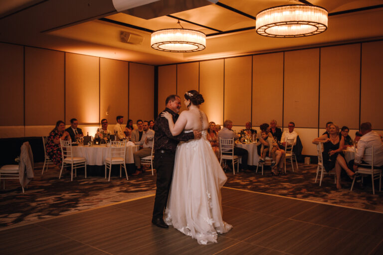 Wedding couple at an event posing romantically in a ballroom embrace on the dance floor - wedding DJ Canberra, 8 til late