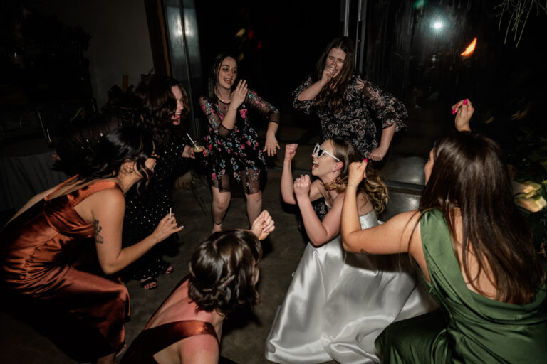 Several women in quirky poses, dancing and having fun at a party in unique fancy outfits - wedding dj canberra, 8 til late