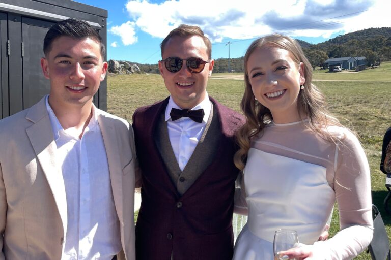 A group photo of three two men and a woman at a daytime wedding event facing the camera - wedding dj canberra, 8 til late