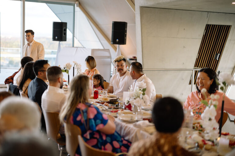 Candit shot of professional people sitting on a dining table having some chat and waiting for the food - wedding dj canberra