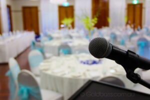 Close-up shot of a mic fixed on a mic stand at a wedding event can be seen in the background - wedding DJs Canberra