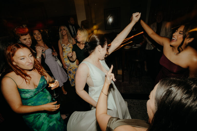 Several women at an indoor even dancing, drinking and enjoying the event party - wedding DJ Canberra, 8 til late